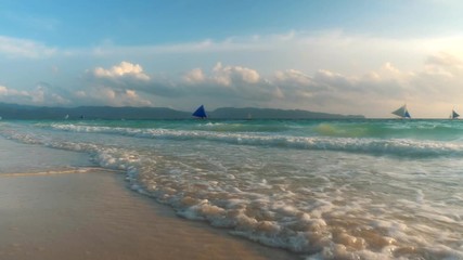 Sticker - Amazing colors of tropical sunset. Sail boats silhouettes floating on ocean horizon. Ocean waves wash the sand. Boracay island, Philippines.