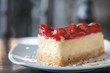 Closeup Slice Strawberry cheesecake layer cake Dessert Food on a white plate in the cafe focus blur background