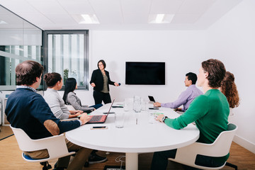 Wall Mural - Group of office workers at a meeting around the boss