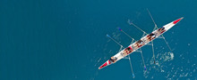 Aerial Drone Ultra Wide Photo Of Sport Canoe With Young Team Of Athletes Practising In Deep Blue Open Ocean Sea