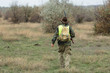© Mountains Hunter - Hunting period, autumn season open. A hunter with a gun in his hands in hunting clothes in the autumn forest in search of a trophy. A man stands with weapons and hunting dogs tracking down the game.