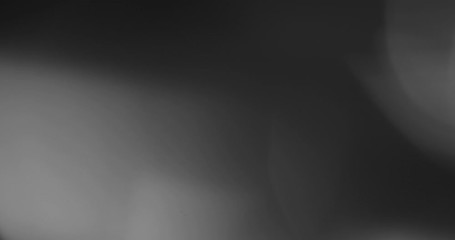 Wall Mural - Abstract bokeh light  background for overlay.  Real Lens flare light effect. Sparkle ray leak on black background. 