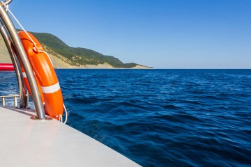 view of the sea landscape with the island from the yacht on a summer day