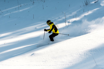 sportsman in goggles holding ski sticks while skiing on snow