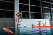 © LIGHTFIELD STUDIOS - handsome and shirtless swimmer standing in starting pose on diving block
