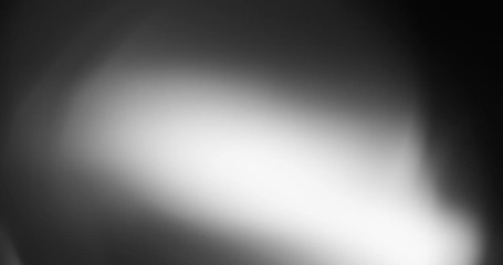 Wall Mural - Abstract bokeh light  background for overlay.  Real Lens flare light effect. Sparkle ray leak on black background. 