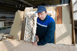 © Светлана Лазаренко - Wood processing plant. Worker in the workshop for the production of beds. The master makes luxury furniture. Carriage screed. Wood processing industry