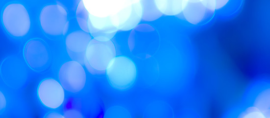 Wall Mural - Abstract Bokeh Blue and green background of defocused glittering lights. Christmas, Party, New Year, luxurious background pattern concept. banner.