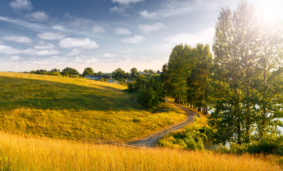 Amazing nature scenery. Summer landscape at sunny day. perfect countryside scenery with blue sky and grassy hillside, glowing sunlit