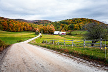 Unpaved Road To A Farm In A Rolling Rural Landscape On A Cloudy Autumn Morning. Beautiful Autumn Colours.