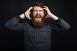 © Vulp - Photo of angry bearded man screaming over dark background