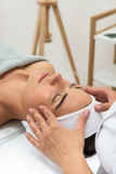Fototapeta  - Odprężona kobieta podczas zabiegu w salonie kosmetycznym. Masaż limfatyczny twarzy. 