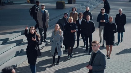 Wall Mural - Multicultural Diverse Office Managers and Business People Suddenly Stop on the Street and Look Up. Unbelievable, Fantastic or Tragic Event Happening Live. Crowd Takes Out Smartphones and Record Video.