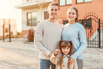 Sticker - Young family with key near their new house