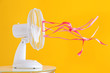 © Pixel-Shot - Electric fan with fluttering ribbons on color background