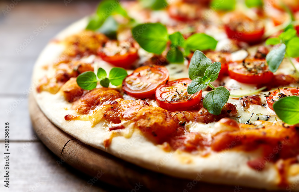 Tasty vegetarian pizza with cherry tomatoes, mozzarella cheese and fresh oregano. Close up. - obrazy, fototapety, plakaty 