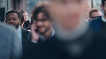 Wall Mural - Diverse and Multicultural Office Managers and Business People Commute to Work in the Morning or from Office on Foot. Pedestrians are Dressed Smartly. People Walking in Downtown. Soft Moving Focus.