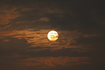 Wall Mural - MORNING SUN SHINING BEHIND THE CLOUDS
