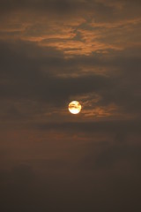 Wall Mural - MORNING SUN SHINING BEHIND THE CLOUDS