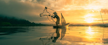Fisherman Throwing Fishing Net During Sunrise.