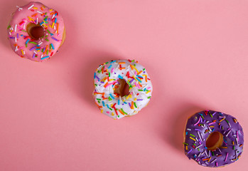 Wall Mural - colorful doughnuts pink background studio