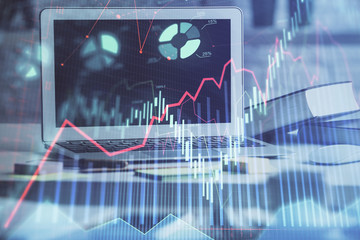 Forex market chart hologram and personal computer background. Double exposure. Concept of investment.