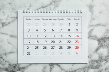 Sticker - Paper calendar on marble background, top view