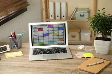 Poster - Modern laptop with calendar app at table in office