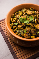 Wall Mural - Tendli / Kundroo sabzi or Kovakkai Poriyal also known as ivy gourd, served in a bowl or karahi. selective focus