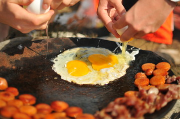 Two eggs cooking over a fire