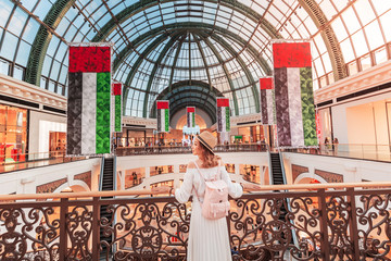 A young tourist walks through one of the largest shopping centers in Dubai - Emirates Mall. Travel in UAE concept