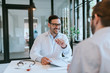 © bnenin - Portrait of a smiling doctor talking with patient about insurance policy