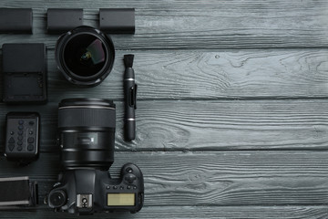 Wall Mural - flat lay composition with equipment for professional photographer on grey wooden table. space for te