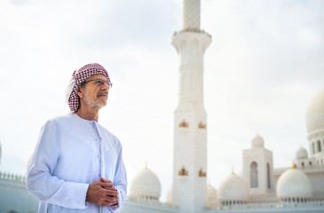 Wall Mural - Arab man visiting the Grand Mosque in Abu Dhabi