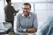© ASDF - close up. smiling businessman sitting at his Desk