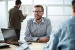 © ASDF - close up. smiling businessman sitting at his Desk