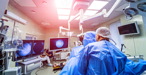 Fotomural Establishing shot of technologically advanced operating room with suregeons ready for operation
