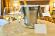 © DannyIacob - Gift in the hotel room, A bottle of champagne and wine glasses in the hotel room, free space for the welcome messagewelcome message