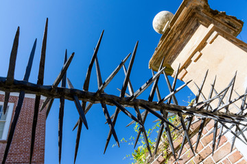 Wall Mural - Within the beautiful historic district of Charleston, South Carolina are many antebellum and Georgian mansions. Detail of a spiked iron gate and fence the of a historic home are seen here.