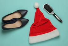 Christmas Shopping. Santa Hat, High Heel Shoes, Comb On Blue Pastel Background. Top View