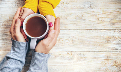 Wall Mural - Cup drink for Breakfast in the hands of lovers. Selective focus.