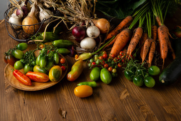 Wall Mural - Fresh vegetables on wooden background, harvest concept