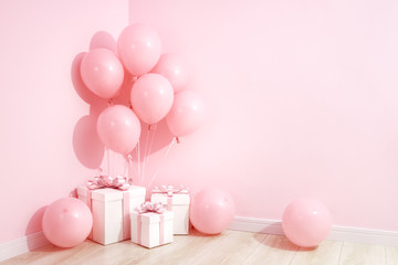 gifts and balloon on the floor at the corner of room.