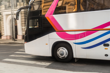 Canvas Print - tourist bus is moving down the street