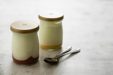 Wall Mural - Fresh yogurt in glass jar with fruit jam. Healthy food, milk diary.