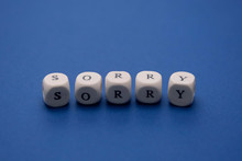 Sorry Word On Wooden Cubes, Clasic Blue Background, Copy Space. Apology Message.