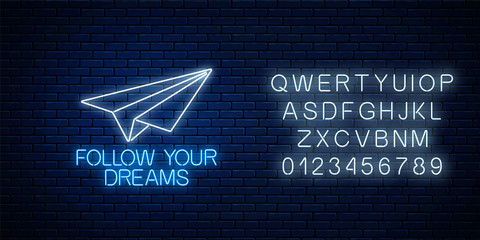 Follow your dreams - glowing neon inscription phrase with paper airplane with alphabet. Motivation quote in neon style.