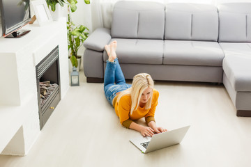 Wall Mural - young woman with laptop works at home