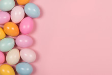 Easter Background With Pastel Colored Easter Eggs On A Pink Background With Space For Copy Seen From A High Angle