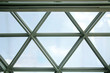 Transparent ceiling with triangular glass units. Structural glazing. Close-up photo of modern architecture fragment. Abstract architectural background with geometric pattern.